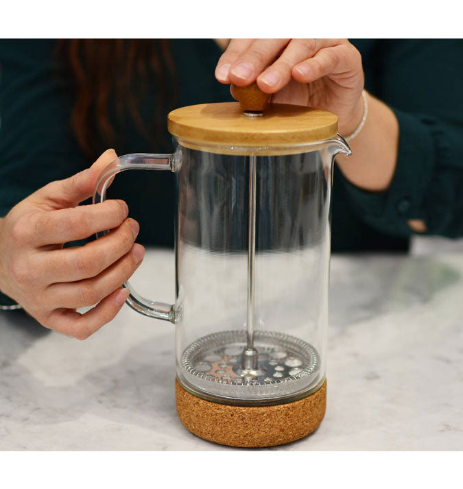 https://homesteadcoffee.com/cdn/shop/products/Groasche-melbourne-bamboo-french-press-on-counter-with-person-1000x1000-Cropped_675x713.jpg?v=1621619406